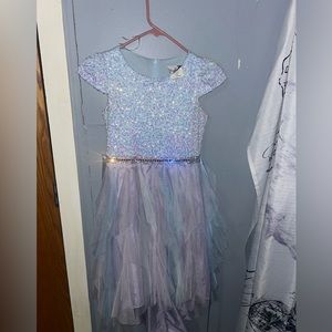 In shades of lavender blue. Has sequins of pink and lavender. Very sparkly